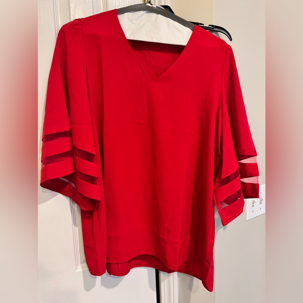 Cute red blouse.  Dress it up or down.